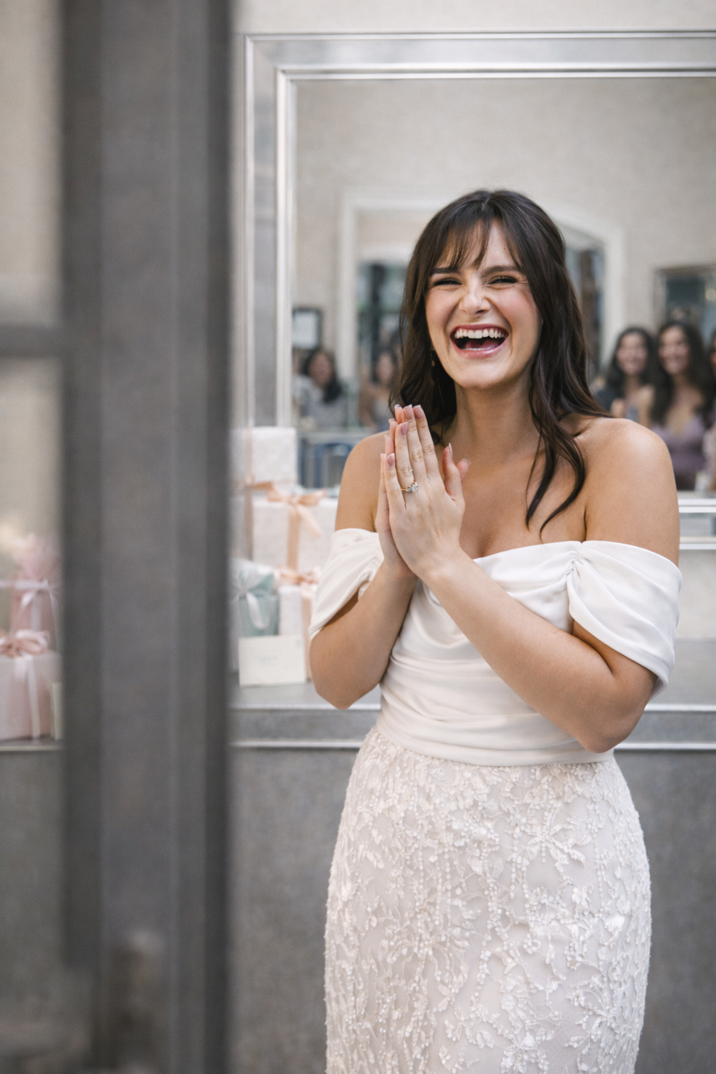 Bride laughing in a white off-the-shoulder dress at her bridal shower luncheon.